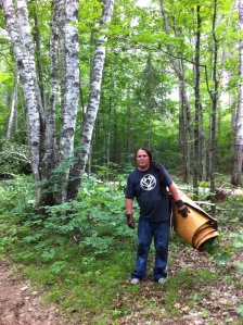 Wayne Valliere, packing canoe bark out of the birch forest, in the summer of 2012. Photo by Tim Frandy